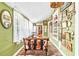 Charming sunroom with antique furniture and eclectic wall decor at 406 N Nichols St., Nichols, SC 29581