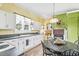 Kitchen boasts white cabinets, wood flooring, and a brick fireplace at 406 N Nichols St., Nichols, SC 29581