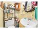 Bathroom with pedestal sink, toilet, and shelving unit at 406 N Nichols St., Nichols, SC 29581