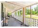 Long wooden front porch with white railings, offering a relaxing outdoor space at 406 N Nichols St., Nichols, SC 29581