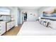 King-size bed, dresser, and view into the living area at 501 S Ocean Blvd. # 308, North Myrtle Beach, SC 29582
