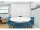 Small round dining table with four blue chairs at 501 S Ocean Blvd. # 308, North Myrtle Beach, SC 29582