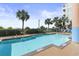 Inviting community pool with surrounding palm trees at 501 S Ocean Blvd. # 308, North Myrtle Beach, SC 29582