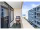 Balcony with chair and partial ocean view at 501 S Ocean Blvd. # 308, North Myrtle Beach, SC 29582