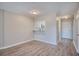 Spacious living room with hardwood floors and a view into the kitchen at 47 Shadow Moss Pl. # 47, North Myrtle Beach, SC 29582