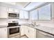 Modern kitchen with stainless steel appliances and granite countertops at 47 Shadow Moss Pl. # 47, North Myrtle Beach, SC 29582