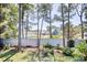 View of backyard with tall trees and neighborhood homes in distance at 47 Shadow Moss Pl. # 47, North Myrtle Beach, SC 29582