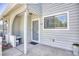Townhome's front entry with a covered porch and sitting bench at 47 Shadow Moss Pl. # 47, North Myrtle Beach, SC 29582