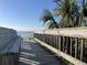 Beach access with a wooden boardwalk and bench at 201 76Th Ave. N # C3, Myrtle Beach, SC 29572