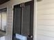 Unit entrance with dark brown shutters and beach decor at 201 76Th Ave. N # C3, Myrtle Beach, SC 29572