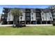Three-story building exterior with balconies and parking at 201 76Th Ave. N # C3, Myrtle Beach, SC 29572