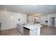 Open concept kitchen with island and view into dining area at 332 Jeff Waters Circle, Longs, SC 29568