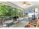 Screened porch with ceiling fan, outdoor furniture, and wooded views at 647 Riverward Dr. # 647, Myrtle Beach, SC 29588