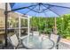 Outdoor patio with table, chairs, and blue umbrella at 647 Riverward Dr. # 647, Myrtle Beach, SC 29588