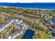 Aerial view of a resort with pools, a pond, and ocean views at 14290 Ocean Hwy. # 210, Pawleys Island, SC 29585