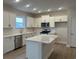 Modern kitchen with white cabinets, quartz countertops, and stainless steel appliances at 1315 Winding Creek Way, Myrtle Beach, SC 29588