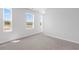 Bright bedroom with neutral carpeting and multiple windows at 289 Sandridgebury Dr. # 65, Little River, SC 29566