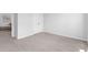 Simple bedroom with double doors to closet and view into Primary bedroom at 289 Sandridgebury Dr. # 65, Little River, SC 29566
