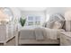Spacious bedroom with white dresser and a large bed at 289 Sandridgebury Dr. # 65, Little River, SC 29566