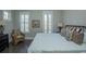Main bedroom with king-size bed, sitting chair, and balcony access at 852 Iris St. # F, Myrtle Beach, SC 29577