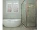 Bathroom featuring a large soaking tub and a glass shower at 852 Iris St. # F, Myrtle Beach, SC 29577