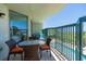 Private balcony overlooking the ocean, pool, and beach with patio furniture at 4301 S Ocean Blvd. # 1C, North Myrtle Beach, SC 29582