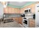 Spacious kitchen with granite countertops, light wood cabinets, and a double sink at 4301 S Ocean Blvd. # 1C, North Myrtle Beach, SC 29582