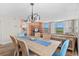 Open concept dining area with ocean view, wood table, and comfortable seating at 4301 S Ocean Blvd. # 1C, North Myrtle Beach, SC 29582