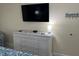 White dresser, large TV, and beach-themed decor at 2000 N Ocean Blvd. # 1807, Myrtle Beach, SC 29577