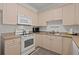 Well-equipped kitchen featuring white appliances and light wood cabinetry at 4861 Luster Leaf Circle # 202, Myrtle Beach, SC 29577