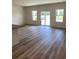 Spacious living room with sliding glass doors and hardwood floors at 934 Oak Hollow St., Longs, SC 29568