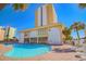 Community pool with lounge chairs and building view at 1207 S Ocean Blvd. # 51404, Myrtle Beach, SC 29577