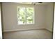 Well-lit bedroom with a large window overlooking trees at 35 Delray Dr. # 2-C, Murrells Inlet, SC 29576