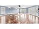 Spacious living room with hardwood floors, a raised platform, and access to deck at 181 Palmetto Harbour Dr., North Myrtle Beach, SC 29582