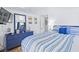 Main bedroom with blue dresser and striped bedding at 6001 - 1193A S Kings Hwy., Myrtle Beach, SC 29575