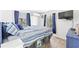 Bedroom with blue striped bedding and a wall-mounted TV at 6001 - 1193A S Kings Hwy., Myrtle Beach, SC 29575