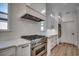 Modern kitchen with stainless steel range, white cabinets and a large vent hood at 205 Brush Ct., Little River, SC 29566