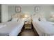 Two beds with nightstand and coastal-themed wall art at 1205 S Ocean Blvd. # 50605, Myrtle Beach, SC 29577