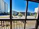 Screened porch with view of complex and ocean at 207 N Ocean Blvd. # 242, North Myrtle Beach, SC 29582