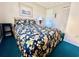 Bedroom with a full-size bed and floral bedding at 207 N Ocean Blvd. # 242, North Myrtle Beach, SC 29582