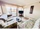 Comfortable living room with floral couches and access to balcony at 207 N Ocean Blvd. # 242, North Myrtle Beach, SC 29582