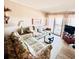Comfortable living room with floral couches and access to balcony at 207 N Ocean Blvd. # 242, North Myrtle Beach, SC 29582
