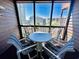 Small patio with table and chairs, overlooking the ocean at 207 N Ocean Blvd. # 242, North Myrtle Beach, SC 29582