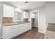 Bright kitchen featuring white cabinets, tile backsplash, and wood flooring at 2183 Highway 544, Conway, SC 29526