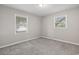 Well-lit bedroom featuring grey carpet and two large windows at 2183 Highway 544, Conway, SC 29526