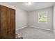 Cozy bedroom with grey carpet, a window, and a dark brown wardrobe at 2183 Highway 544, Conway, SC 29526