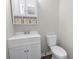 Small bathroom with white vanity, toilet and a mirrored medicine cabinet at 2183 Highway 544, Conway, SC 29526