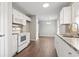 Open concept kitchen with white cabinets, new appliances, and wood floors at 2183 Highway 544, Conway, SC 29526