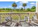 Private balcony overlooking a grassy area with mature trees at 1100 Possum Trot Rd. # C-101, North Myrtle Beach, SC 29582
