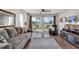 Bright living room with hardwood floors, sliding doors to balcony, and comfortable seating at 1100 Possum Trot Rd. # C-101, North Myrtle Beach, SC 29582